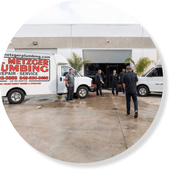 Plumbing technicians with branded trucks